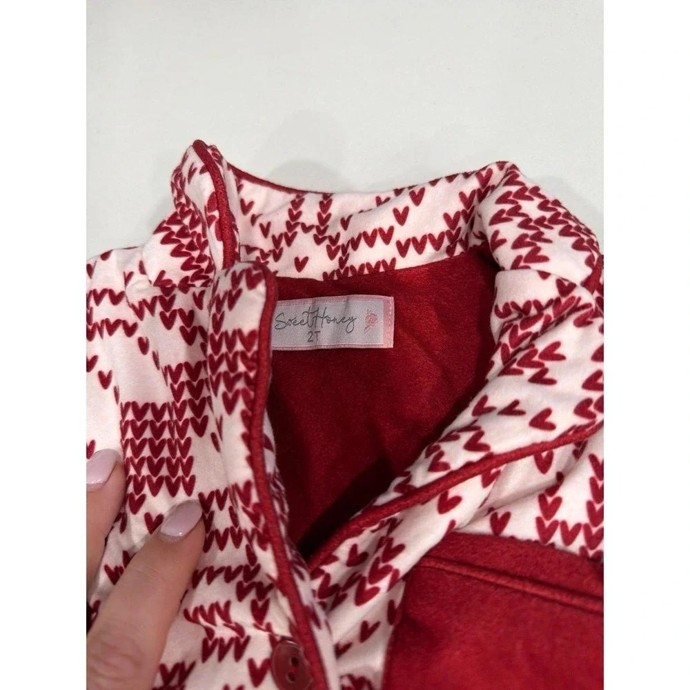 Sweet Honey pajama set features a festive red and white snowflake pattern 2T